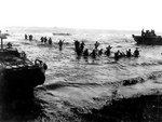 US Marines wading toward Tinian from amphibious tractors and landing boats, Mariana Islands, 25 Jul 1944, photo 2 of 3