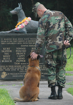 Petty Officer 2nd Class Blake Soller and Military Working Dog Rico at the War Dog Cemetery at Naval Base Guam, Santa Rita, US Territory of Guam, 24 May 2009