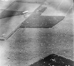 Reconnaissance photograph showing Dakota aircraft dropping paratroopers of 1st Airborne Brigade on to Dropping Zone 