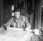 Brigadier P. H. W. Hicks studying a map at Divisional Headquarters during the advance to Arnhem, Netherlands during Operation Market Garden, 18 Sep 1944