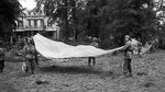 British 1st Airborne soldiers using parachutes to signal to Allied supply aircraft from the grounds of Division HQ at the Hartenstein Hotel in Oosterbeek, Netherlands, 23 Sep 1944