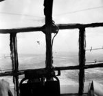 A photograph taken through the window of a troop carrying glider during Operation Market Garden, 17 Sep 1944; note other Allied aircraft and the Dutch coast in distance