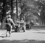 Men of the UK 2nd Battalion, South Staffordshire Regiment marching with their vehicles and equipment along a road between Oosterbeek and Arnhem, the Netherlands, 19 Sep 1944