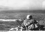 German paratrooper observing lower ground from Monte Cassino, Italy, Feb 1944