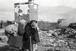 Russian civilians looking at the ruins of their former home at Serpukhov south of Moscow, Russia, late 1941 or early 1942