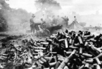 Spent 75-mm howitzer shells piling up outside the besieged city Myitkyina, Burma, mid-1944; note M1 carriage