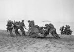 British troops moving supplies and a motorcycle on the beaches of Algiers, Operation Torch, Nov 1942