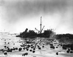 Remains of a merchant ship that exploded, causing a fire on another British freighter, off Algiers, Algeria, 17 Jul 1943