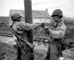 US Army African-American soldiers T/5 Dexter Clayton and M/Sgt. Nelson T. Ewing tying wire to form a fence, France, 25 Jul 1944; note Springfield M1903 rifle and M1 Carbine (partially hidden)