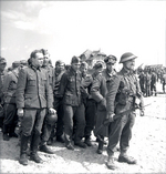 Two German officers in a group of prisoners who surrendered to the Canadians in Bernières-sur-mer, Normandy, France, 6 Jun 1944