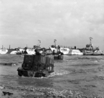 Universal carriers of British 50th Division waded ashore from landing craft on Gold Beach, Normandy, France, 6 Jun 1944