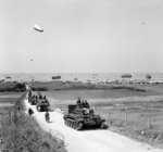Vehicles of 4th County of London Yeomanry, UK 7th Armored Division moving inland from Gold Beach, Normandy, France, 7 Jun 1944; note Cromwell tank leading the column
