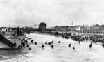 Men of Canadian 9th Infantry Brigade disembarking from LCI(L) landing craft onto Nan White Beach near Bernières-sur-Mer, Juno Beach, Normandy, France, late morning 6 Jun 1944; note many with bicycles. Photo 1 of 2.