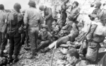 Men of 3rd Battalion, 16th Infantry Regiment, US 1st Infantry Division, resting at the beach at Omaha Beach near Colville-Sur-Mer, Normandy, France, 8 Jun 1944