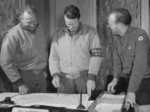 Commander of the US Army Transportation Corps Colonel C. W. Richmond (center) examining a road map at the 