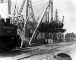 An American locomotive was transferred from SS Seatrain Texas, Cherbourg, 13 Jul 1944, to replace one of the many destroyed during the Allied invasion of Normandy, photo 1 of 2