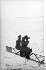 Two men of a German military film unit at work on a bridge in Denmark, 1940