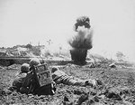 US Army observers calling in artillery fire against a Japanese position on Okinawa, Japan, circa Apr-Jun 1945
