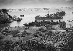 American ships landing troops and supplies on a beach on Okinawa, Japan, 13 Apr 1945