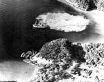 Aerial photograph taken during bombing of a Japanese forward submarine base on Okinawa, Japan, Mar 1945