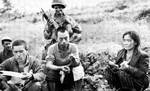 Japanese resistance fighters captured, Okinawa, Japan, Jun 1945; prisoner to the far left reading American propaganda literature