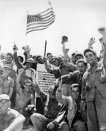US Marines and US Army soldiers celebrating the capture of Hill 89, Okinawa, Japan, 27 Jun 1945; the hill was captured by US Army 7th Inf Div on 21 Jun
