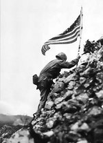 US Marine Lieutenant Colonel R. P. Ross, Jr. raising an US flag over Shuri castle on Okinawa, Japan, 29 May 1945, photo 2 of 2