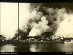 Smoke rising from the port facilities at Oosthaven, Sumatra as Allied personnel set fires during the withdrawal, 20 Feb 1942