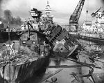 Wrecks of destroyers Downes and Cassin in Drydock One at Pearl Harbor Navy Yard, 7 Dec 1941, photo 2 of 5; note Pennsylvania in the rear