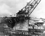 Blistered paint and other fire damage to the forward hull of battleship Pennsylvania, in Drydock Number One at the Pearl Harbor Navy Yard, 7 Dec 1941