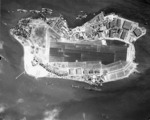 Vertical aerial photograph of Ford Island, Pearl Harbor, US Territory of Hawaii, 10 Nov 1941; note Battleship Row on top, USS Lexington at bottom, and PBY aircraft at upper right
