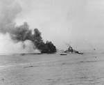 APD Ward burning in Ormoc Bay, Leyte, Philippine Islands, after being struck by special attack aircraft, 7 Dec 1944; the firefighting ship was destroyer O