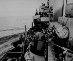 Gun crew of cruiser Phoenix tried to identify an aircraft above, off Mindoro, Philippine Islands, 15 Dec 1944