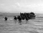 First wave of American troops storming ashore from amphibious landing craft, Leyte, Philippine Islands, 20 Oct 1944, photo 2 of 3