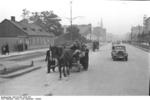 A horse-drawn cart and an automobile on a street in Warsaw, Poland, Sep-Oct 1939