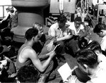 Soldiers and sailors singing hymns during religious services on board LST-4 en route to Southern France, 13 Aug 1944