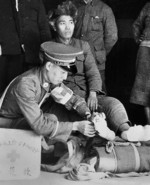 Wounded interned Chinese soldier receiving treatment, Shanghai international settlement zone, China, late 1937