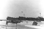 LCVPs from APAs Barnett and Monrovia unloaded supplies onto the beach near Gela, Sicly, 10 Jul 1943; note LST-344 and LST-338 in background