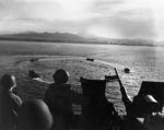 LCVP landing craft circling off Cape Torokina, Bougainville, Solomon Islands while awaiting orders, 1 Nov 1943; note 20mm Oerlikon AA gun; photographed from aboard APA-13 USS American Legion