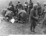 Spanish Nationalist troops treating a wounded comrade, Battle of Guadalajara, Spain, Mar 1937