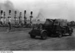 A German truck driving through the ruins of Stalingrad, Russia, with columns of smoke visible in background, Sep 1942