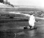 Japanese freighter at Truk, Caroline Islands hit by a torpedo dropped from a US Navy squadron VT-10 Avenger aircraft, 17 Feb 1944, photo 1 of 2