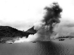 Smoke rising from the Japanese naval base at Dublon Island, Truk Atoll, Caroline Islands, 29-30 Apr 1944