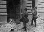 Ukranian troops of a SS auxiliary unit looking at executed Jews in Warsaw, Poland, Apr-May 1943