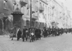 Jews marching along Zamenhofa Street toward the Umschlagplatz rail station for deportation, Warsaw, Poland, Apr-May 1943