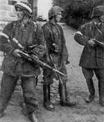 Polish resistance fighters Wojciech Omyla, Juliusz Bogdan Deczkowski, and Tadeusz Milewski in captured German uniforms and Kar98k rifles, Warsaw, Poland, 5 Aug 1944