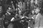 Polish resistance fighter Captain Cyprian Odorkiewicz posing with captured German insignia, Okólnik gardens, Warsaw, Poland, 14 Aug 1944; note captured MP 40 submachine gun