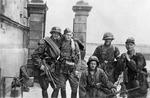 Polish resistance fighters Wlodzimierz Denkowski (with Thompson submachine gun), Lech Zubrzycki, Jan Baginski, and Zygmunt Siennicki (with MP35 submachine gun), Warsaw, Poland, circa 11 Aug 1944