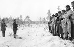 Finnish Army Lieutenant Aarne Juutilainen and his company holding a Christmas service near the Kollaa River, Finland, 24 Dec 1939