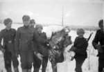 Finnish troops posing with the frozen corpse of a Soviet soldier, Finland, 1940